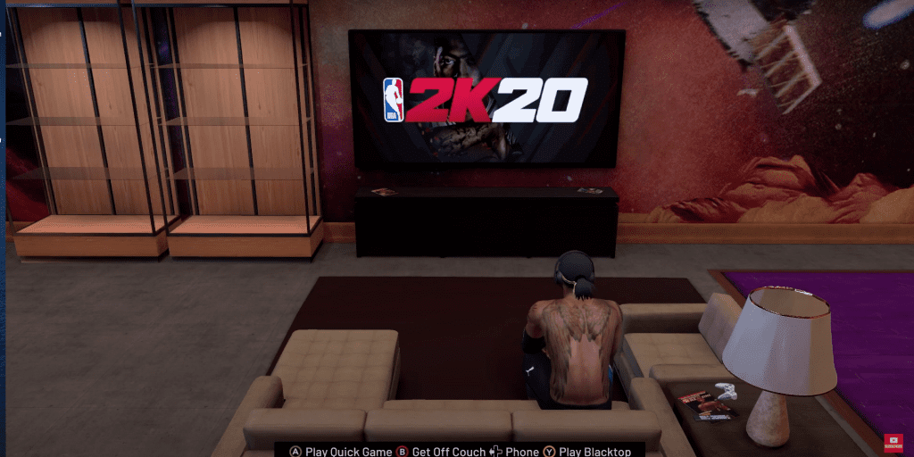 MyPlayer from Mycareer sitting on couch in MyPlayer loft in Mycourt. NBA 2K20 logo on screen of TV
